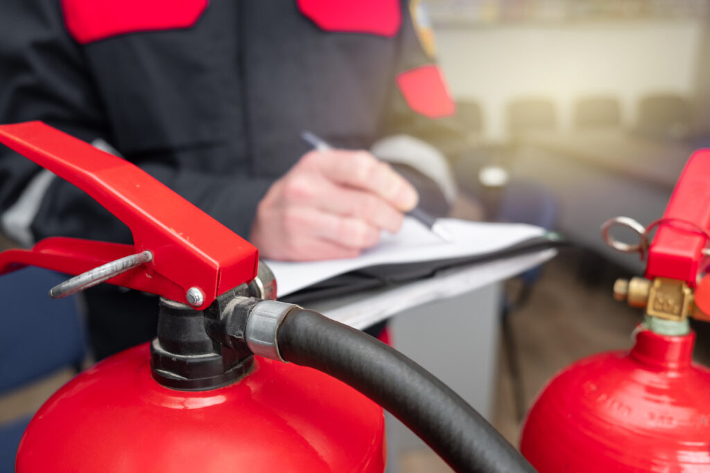 Engineer Professional are Checking A Fire Extinguisher Using Clipboard or checking Industrial fire control system,Fire Alarm controller, Fire notifier, Anti fire.System ready In the event of a fire.